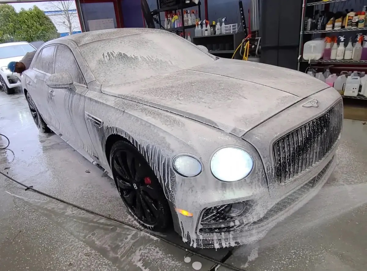 Foam hand wash on a Bentley, presented as their work.