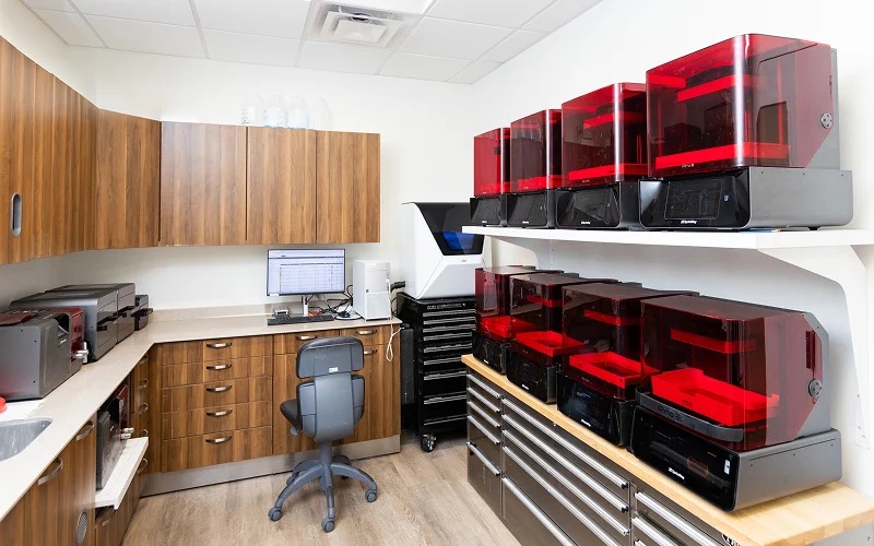 The practice's in-house lab with a bank of 3D printers