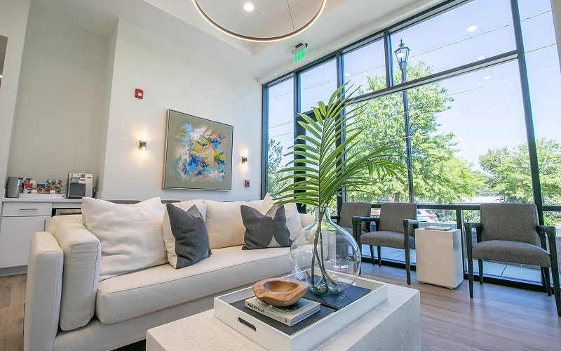 The office's patient lounge with windows onto the trees