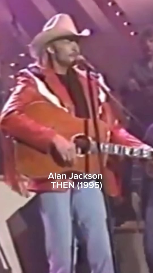 Alan Jackson on stage in 1995 in a white hat, with an acoustic guitar