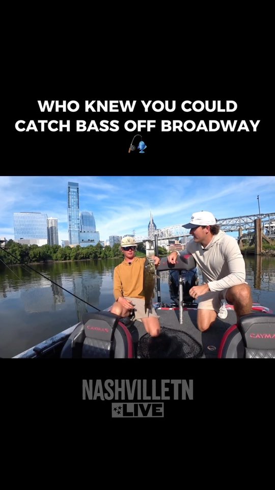 Two anglers in a bass boat with the downtown skyline behind them