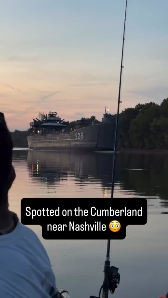 The LST-325 on the Cumberland at dusk, seen from a fishing boat